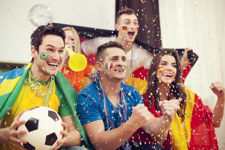 Multinational football supporters celebrating goal